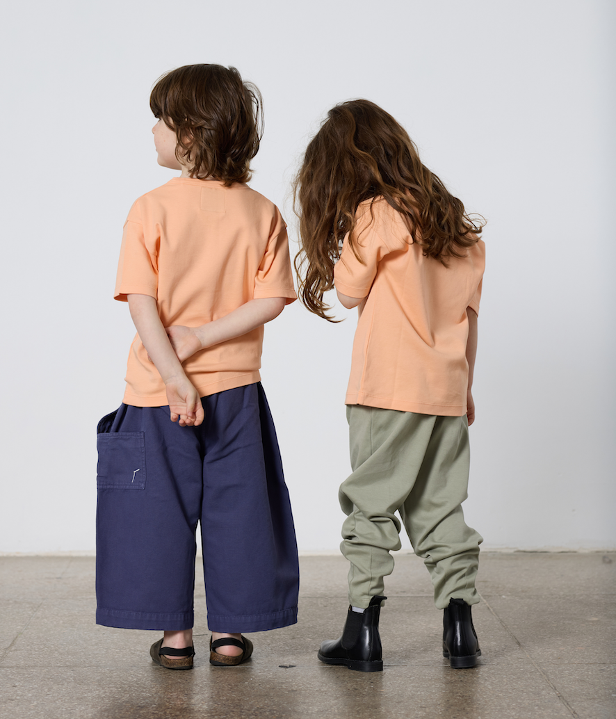 Little boy and little girl wearing TwoThirtyTwo, facing away.